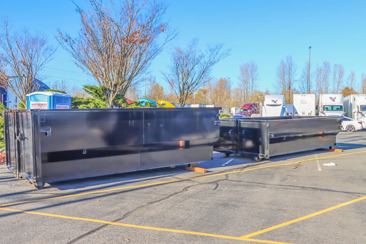 Professional dumpster rental service with roll-off container on residential driveway in Aiken